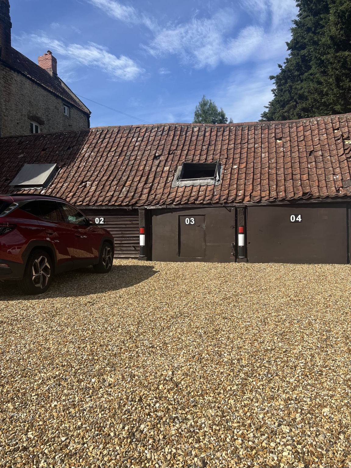Parking bay numbers 02, 03 and 04 visible on the farm doors